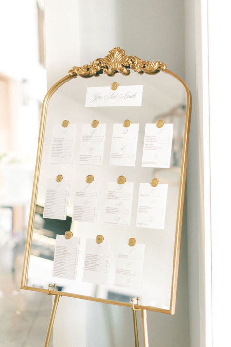 Vintage gold mirror and wax seal escort sign/seating chart for elegant weddings #vintagewedding #goldescortsign #goldseatingchart #mirrorseatingchart #mirrorweddingsign Seat Labels Wedding, Wedding Table Seating Chart Mirror, Seating Chart On Gold Mirror, Vintage Mirror Seating Chart Wedding, Wedding Gold Mirror, Wax Seal Mirror Seating Chart, Gold Mirror Wedding, Gold Mirror Seating Chart Wedding, Classy Seating Chart Wedding