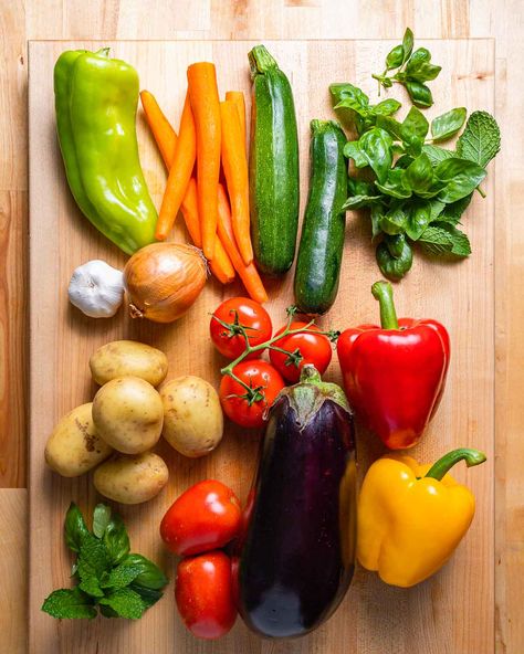 Ciambotta combines zucchini, eggplant, carrot, peppers, tomatoes, and potatoes. My recipe includes cherry peppers for some added heat and flavor. Topped with fresh herbs like basil and mint, and served with crusty Italian bread, this is the summer veggie recipe you need to make! #ciambotta #ratatouille #veggiestew #summerrecipes #italianrecipes Eggplant Cherry Tomatoes, Ciambotta Recipe, Carrot Peppers, Recipe Using Zucchini, Crusty Italian Bread, Veggie Stew, Sip And Feast, Cherry Peppers, Canned Plums