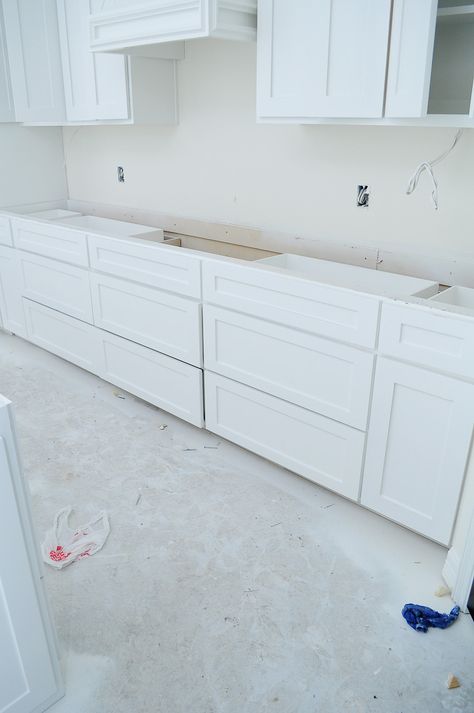 White kitchen with decorative vent hood and large island. Alabaster by Sherwin-Williams in a matte sheen for walls. | via monicawantsit.com Alabaster Walls With White Cabinets, Pure White Kitchen Cabinets, Kitchen Paint Color Inspiration, Update Walls, Alabaster Walls, House Being Built, Small Hanging Lights, Hanging Wood Shelves, Tray Ceilings