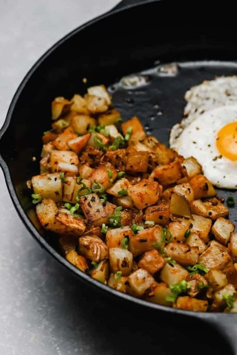 When you're craving diner-style breakfast potatoes, make these fried potatoes and onions! Parboil the potatoes, then get 'em all crispy in a cast iron skillet. Season with garlic, paprika, then serve with a couple of fried eggs for the complete diner experience. Brunch goals at home! #wellseasonedstudio #breakfastpotatoes #panfried #potatoes #skilletpotatoes Pan Fried Potatoes And Onions, Fried Breakfast Potatoes, Fried Potatoes And Onions, Home Fried Potatoes, Crispy Breakfast Potatoes, Breakfast Potatoes Skillet, Eggs Potatoes, Pan Fried Potatoes, Potato Breakfast Recipes