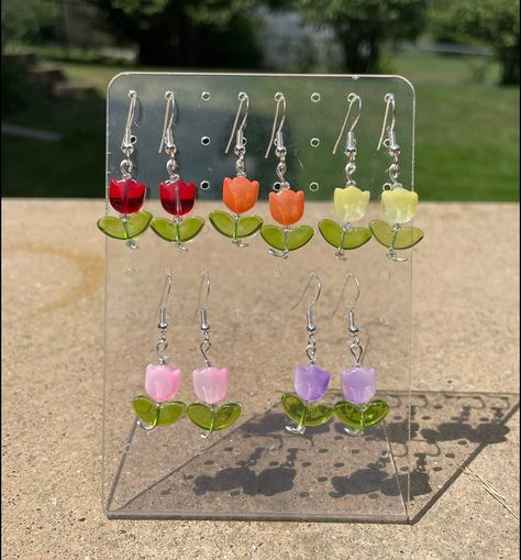 Tulip earrings 🌷$10 a pair. Find them on Etsy at KashewCrafts!! #kashewcrafts #smallbusiness #handmade #etsy #shopsmall #supportsmallbusiness #tulips #glassbeads #flowers #floral #giftideas #christmasgifts #earrings #jewelry #accessories #valentines #valentinesgift #mothersday #mothersdaygift #easter #eastergifts Arty Ideas, Tulip Earrings, Hama Bead, Mothersday Gifts, Easter Gifts, Work Ideas, Beaded Jewelry Diy, Hama Beads, Jewelry Diy