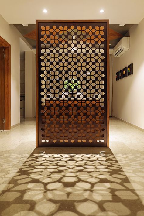 Floral Pattern Inspires Apartment Interiors | Studio 7 - The Architects Diary Wooden Screen Door, Wall Partition Design, Wall Partition, Wooden Partitions, Jaali Design, Furniture Design Inspiration, Pooja Room Door Design, Wooden Screen, Pooja Room Design