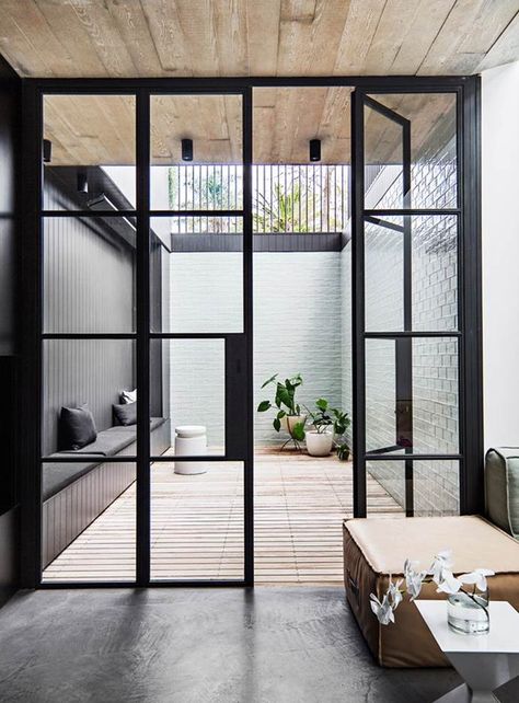 Steel-frame doors are versatile, befitting a variety of home styles including industrial, modern and art deco. Take inspiration from these 11 examples that will have you rethinking your next renovation. Sunken Courtyard, Balcony Door, Folding Partition, Steel Frame Doors, Rumpus Room, Green Tiles, Steel Door Design, Northern Light, Internal Courtyard