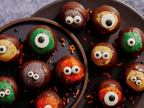 Hosting a houseful of hungry ghosts and goblins this year? You're going to need a few sweet treats (and we're not talking about the cauldron of Halloween candy you put out for the neighborhood kids as they go door to door). We're talking about going all-out with fun, festive desserts for get-togethers big or small: creepy-cute cookies for some pre-trick-or-treating fuel, dinner party-worthy cakes and cupcakes, frightfully fun rice cereal brains for your at-home haunted house—and even more. With Food Network Buckeyes, Halloween Buckeye Balls, Halloween Buckeyes Recipe, Halloween Buckeyes, Buckeye Recipe, Fun Halloween Desserts, Halloween Potluck, Buckeyes Recipe, Candy Eyeballs