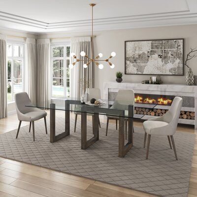 The dining table with its unique modern design features a serpentine wood base that is the focal point of the piece. This geometric base design "snakes" along mitered joints that are a sturdy foundation for the rectangular glass table top. Modernize any space with the sleek look of glass and the warm tones of solid maple hardwood. Setup is a breeze. Simply unpack and place the glass top on the base. The table base comes equipped with levellers on the bottom that can be adjusted with a simple twi Dining Room Decor Modern Contemporary, Glass Dining Room Table Decor Rectangle, Dinningroom Table, Dinning Light, Glass Dining Table Decor, Glass Kitchen Table, Luxe Dining Room, Vegas Living, Glass Dinning Table