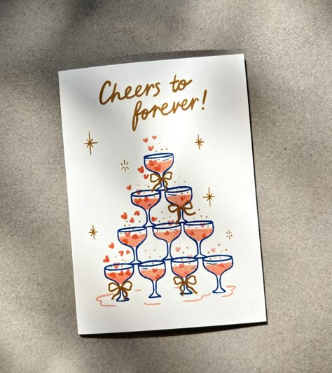 Share a toast to love and laughter with this "Cheers to Forever" greeting card. Featuring a softly illustrated champagne glass tower adorned with bows, this card is ideal for a wedding, engagement or anniversary. Send some sparkle to your favourite couple, and cheers to a lifetime of beautiful moments! 🥂✨ Blank inside for a personal message- A6 / 105 x 148mm - Printed in Australia on 100% recycled paper- Comes with a 100% recycled Kraft envelope and packaged in a recyclable cello bag - Sustaina Cheers To Forever, Cute Wedding Cards Ideas, Wedding Cards Painted, Engagement Card Watercolour, Watercolor Engagement Card, Wedding Card Art, Wedding Watercolour Card, Wedding Cards Handmade Marriage, Homemade Engagement Cards