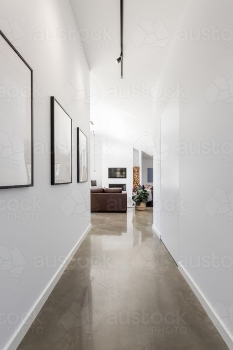 Bright white contemporary new home entrance hall to living room : Austockphoto Track Lighting Hallway, Lighting Hallway, Bath Runner Rugs, Casual Decor, Hallway Lighting, Stained Concrete, Large Wall Decor, Polished Concrete, Entrance Hall