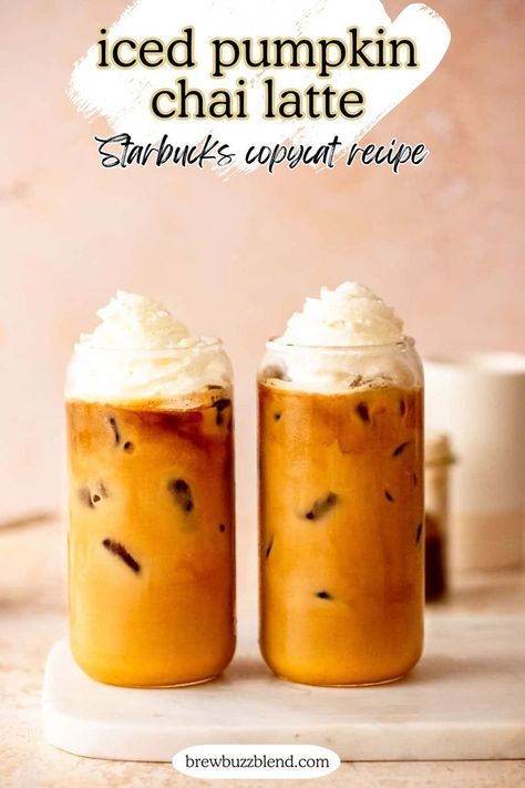 Two iced pumpkin chai lattes topped with whipped cream sitting on a marble slab. Pumpkin Chai Latte Starbucks, Pumpkin Spice Tea Recipe, Flavored Latte Recipes, Pumpkin Spice Chai Latte Recipe, Pumpkin Chai Tea Latte, Pumpkin Chai Latte Recipe, Chai Latte Starbucks, Pumpkin Chai Latte, Pumpkin Chai Tea