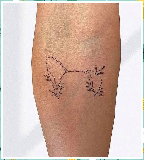 A minimalist design to honor your pup's playful spirit. Dog Ear Fine Line Tattoo, Tattoos Dedicated To Dogs, Dog Ear Tattoo With Name, Simply Dog Tattoo, Fine Line Dog Tattoo Ideas, Dog Honor Tattoo, Sentimental Dog Tattoos, Dog Ear Tattoo With Flowers, Simple Line Dog Tattoo