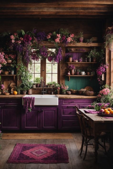 Discover a slice of paradise in this majestic floral-infused rustic kitchen. Dark wooden beams and log walls evoke a cabin feel, while resplendent purple cabinetry and a farmhouse sink add modern flair. Cascades of verdant greenery and vibrant flowers drape from above, creating an ethereal atmosphere. A weathered wooden table, adorned with fresh fruits and blooms, awaits warm gatherings. The charming open shelves exhibit earthenware amidst the foliage. Witchy Studio, Witchy Farmhouse, Studio Seni, Library Kitchen, Witchy Apothecary, Apothecary Kitchen, Witchy Kitchen, Whimsical Kitchen, Witchy Home