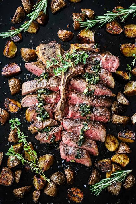 An overhead view of bistecca alla fiorentina that has been cut into slices, topped with sautéed herbs and surrounded by roasted balsamic potatoes. Italian Steak Recipes, Steak Florentine Recipe, Blueberry Buttermilk Pie, Fiorentina Steak, Italian Mains, Balsamic Potatoes, Porterhouse Steak Recipe, Cooking Vision Board, Italian Steak