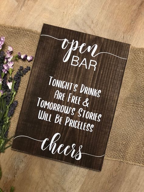 "Wedding/Party/Special Occasion Real Wood Block Sign \"Open Bar Tonight's Drinks Are Free & Tomorrow's Stories Will Be Priceless Cheers\" The wood for this sign is stained to the color of your choosing and the wording is a high quality permanent vinyl. This item is designed to stand/lean against something so it can be placed on a shelf or table with something behind it to lean on for stability. If you prefer to hang the sign on the wall please let me know in the notes so I can add a sawtooth Party Bar Decor, 2026 Wedding, Open Bar Wedding, Ring Bearer Signs, Ribbon Display, Backyard Reception, Rustic Bar, Party Bar, Open Signs