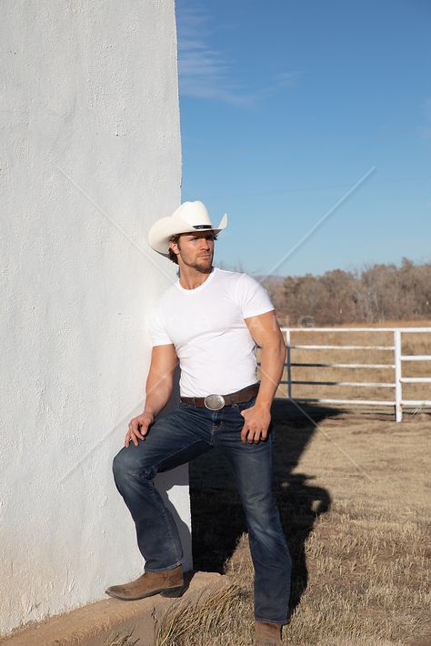 hot cowboy leaning against a white wall on a ranch | ROB LANG IMAGES: LICENSING AND COMMISSIONS Cowboy Tshirt Outfit, Hot Cowboy Outfit, Cowboy Formal Wear Men, Cowboy Men Outfit, Mens Cowboy Outfit, Modern Cowboy Style Men, Cowboy Outfits Men, Western Outfit Men, Cowboy Fits