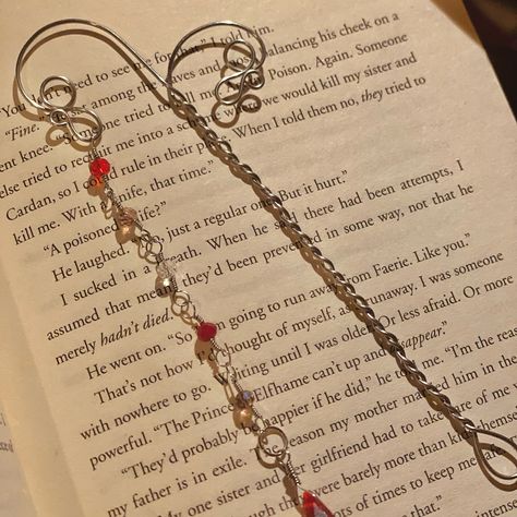 Bookmarks are here!📚 Do you find yourself always with a book on your hands, traveling from one world to another? These bookmarks will sure remind you of all the adventures you’ve been on with your favorite books⚔️ Wire wrapped bookmarks with beautiful charm chains because a lovely book spine deserves a stunning charm chain, just like we deserve stunning jewelry!🌞 🌻 DM for details 🌻 #bookmarks #handmade #wirewrapping #wirewrap #bookstagram #booklover #bookaddict Charm Bookmark Diy, Wire Wrapped Bookmark, Handmade Bookmark Ideas, Wire Bookmarks, Homemade Bookmarks, Book Charm, Charm Bookmark, Beaded Bookmarks, Book Spine