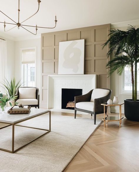 Who doesn't love curling up in front of a fireplace during those cold nights? This beige living room features exposed timber floors, a white textured rug, marble coffee table, two-tone chairs, taupe wall panelling and a white brick fire place that creates a great focal point! Whether you're looking for living room fireplace inspo or just want contemporary living room inspo, find our round up of cool fireplaces by clicking on the pin! Grid Fireplace, Taupe Fireplace, Yorkshire Cottage, Herringbone Fireplace, Fireplace Tile Ideas, Fireplace Accent Walls, Transitional Fireplace, Transitional Living, Fireplace Remodel