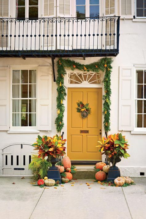 A door painted in a cheery marigold hue is so autumnal when paired with a scattering of pumpkins. Yellow Front Door, Creative Pumpkin Decorating, Yellow Front Doors, Fall Front Porch Ideas, Pumpkin Topiary, Yellow Door, Creative Pumpkins, Fall Door Decorations, Fall Front Door