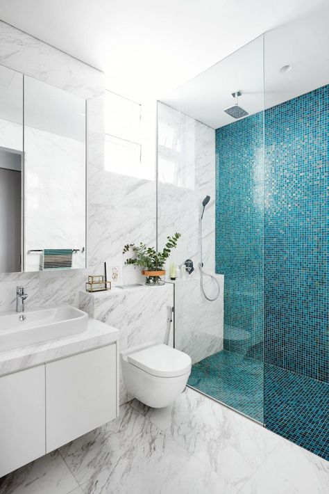 Example of a trendy blue tile, white tile and mosaic tile marble floor walk in shower design in Singapore with flat panel cabinets, white cabinets, a wall mount toilet and a vessel sink Design Interior Baie, Projek Menjahit, Compact Bathroom, Washroom Design, Decor Baie, Small Bathroom Makeover, Blue Tile, Bathroom Tile Designs, Bathroom Design Decor