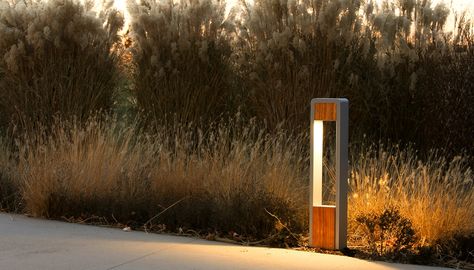 The DUO Bollard adds beauty an art in addition to ample lighting for public outdoor spaces. The DUO Bollard is aluminum with wood accents and LED lighting. Garden Lighting Bollards, Bollard Design, Exterior Lighting Design, Teak Decor, Lighting Candle, Garden Lamp Post, Column Lighting, Driveway Lighting, Metal Columns