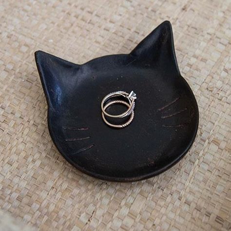 The Black Cat Tray is a shallow black resin tray in the shape of a cat face. The tray is made complete with subtle distressed details and whisker indents. This tray makes a great gift and can be used to hold jewelry, keys, or other small trinkets. Measures 1" high by 4" long by 3.75" wide. Cat Clay Tray, Clay Draping, Black Cat Pottery, Jewelry Dish Clay, Clay Jewelry Tray, Cat Ashtray, Trinkets Dish, Cat Trinket Dish, Ceramics Cat