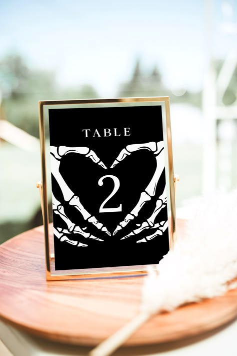 Halloween Wedding Table Numbers Template Enhance the gothic charm of your wedding reception with our dark and moody table number signs. These charming templates feature a beautiful dark and moody design and are perfect for your fall wedding, winter wedding or gothic bridal shower! This is a digital file *only*. No physical items will be provided upon purchase. After purchase, the template is available immediately for editing using Templett's online app in your browser (no software download requi Rustic Gothic Wedding Decorations, Goth Chic Wedding, Black Linens For Wedding, Gothic Table Numbers, Maroon And Black Wedding Decorations, Moody Table Numbers, Dark Moody Wedding Reception, The Lovers Wedding Theme, Dark Gothic Wedding Aesthetic