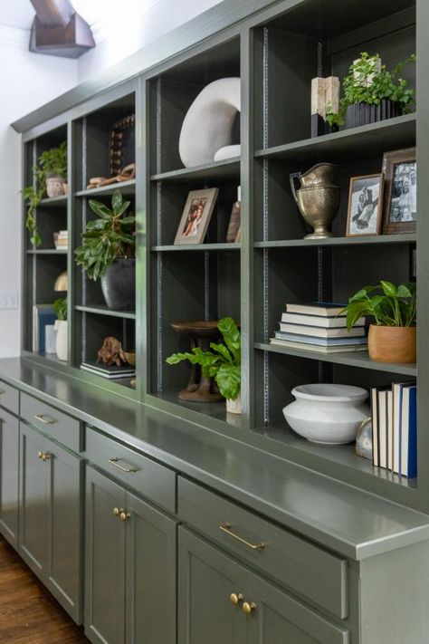 Tour Jenn Todryk’s No Demo Reno of her Best Friends’ Forever Home | No Demo Reno | HGTV Bookshelves Over Cabinets, Built In Bookshelves With Doors, Shelves With Cabinets, No Demo Reno Hgtv Living Room, Blue Green Built Ins, Old Built In Cabinets Makeover, Built In Bookshelves Green, No Demo Reno Hgtv, Teal Built In Bookcase