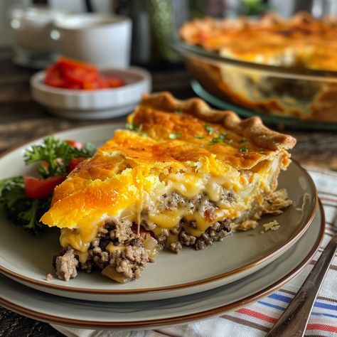 Impossibly Easy Cheeseburger Pie is a deliciously savory dish that’s filled with seasoned ground beef and topped with a rich, cheesy crust. It’s not heavy or overly complicated, making it a perfect weeknight meal. If you’re not a fan of ground beef, feel free to use ground turkey or chicken.   It will still be undeniably delicious! If you’re looking for a comforting and hearty meal that’s easy to prepare, you’ve come to the right place. When you combine the flavors of a classic cheeseburger ... Ground Beef Pie, Ground Turkey Pie, Bisquick Cheeseburger Pie, Cheeseburger Pie With Crust, Crescent Roll Cheeseburger Pie, Bisquick Cheeseburger Pie Recipes, Catalina Dressing Recipes, Impossibly Easy Cheeseburger Pie, Pillsbury Pie Crust