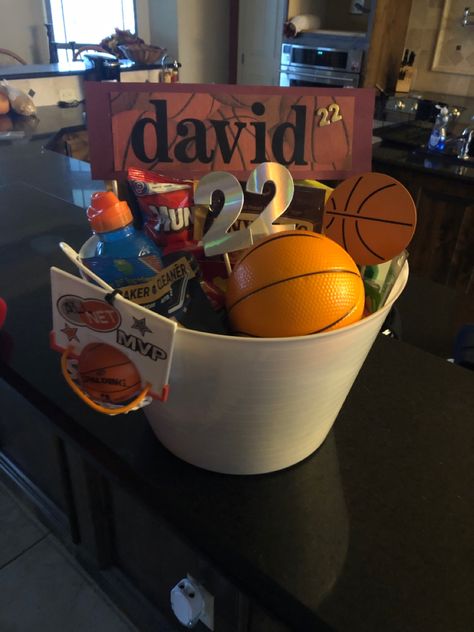 DIY basket for Basketball Senior 
Dollar Store finds ... basket , misc items , and snacks 
The basketball net was a cake topper i recycled Boys Senior Night Gift Ideas, Senior Gift Baskets Sports, Senior Night Basketball Baskets, Soccer Senior Night Baskets, Senior Night Gift Baskets Basketball, Soccer Basket Ideas Gift, 8th Grade Night Basketball Gift Ideas, Basketball Senior Night Gifts Baskets, Senior Night Gift Basket