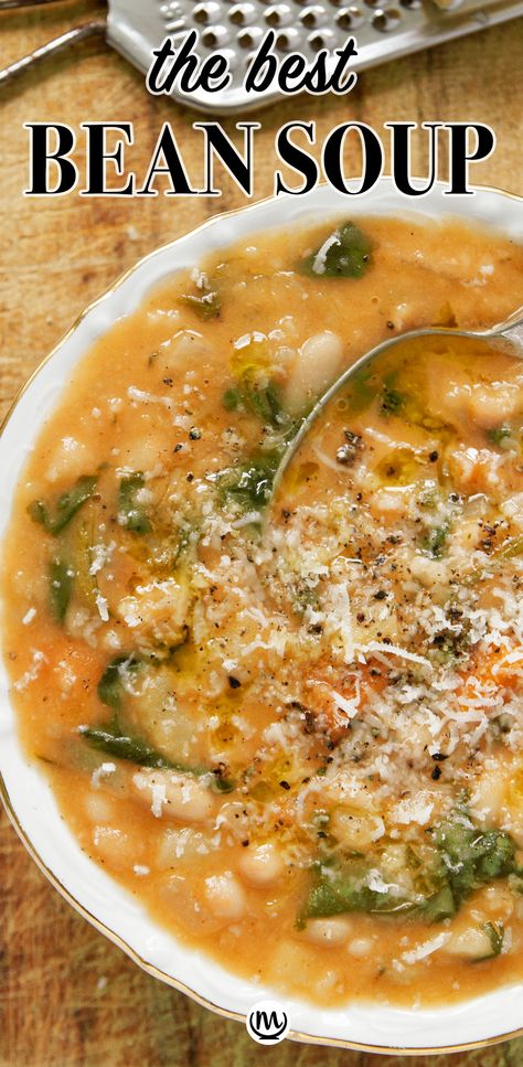 Top view of a white bowl full of white bean soup over a wooden background. Portuguese White Bean Soup, Best Bean Soup Ever, White Bean And Lentil Soup, The Best White Bean Soup, Spicy White Bean Soup, Fall Bean Soup Recipes, Cajun White Bean Soup, Quick White Bean Soup, Hearty Bean Soup Recipes