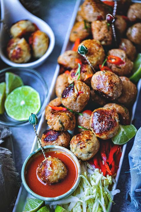 These Thai Tom Yum meatballs with ground chicken have all the Thai flavors rolled up into one herbaceous bite. The famous flavors come through with Tom Yum paste and fresh aromatics in this delicious appetizer. Healthy, flavorful, and extra addictive! #tomyummeatballs #thaitomyumrecipe #thaimeatballs #thaitomyumrecipes #tomyumrecipes #Asianmeatballs Thai Meatball Recipes, Sticky Thai Meatballs, Thai Appetizers, Asian Inspired Appetizers, Asian Hors D'oeuvre, Sweet Thai Chili Meatballs Crock Pot, Meatballs Appetizers For Party, Asian Appetizers For Party, Thai Appetizer Recipes