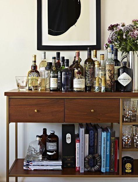 #refinery29  http://www.refinery29.com/tina-ramchandani-nyc-apartment-design#slide-6  What are your secrets to creating a gorgeous bar cart?"I love to style pieces so they look like part of the space, in addition to functioning as expected. A bar doesn't always have to look like a bar. This piece is actually an étagère we are using as a bar. I added books, plants, and objects to help this feel like a bookcase in addition to a bar cart. This also helped the bar ... Minimalist Bachelor Pad, Ikea Minimalist, Beds Minimalist, Nyc Apartment Design, Interiors Minimalist, Plants Minimalist, Shelves Minimalist, Bachelor Pad Decor, Architecture Minimalist