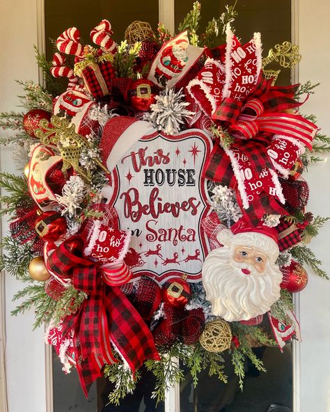 Show Santa you believe in him with this whimsical wreath. Features a center sign on a luxe flocked wreath base. Accented with a jolly plastic Santa head. Surrounded by various themed picks. Finished off by two fabulous bows and ribbon waterfalls.  Measures approximately 22x24 inches.  Please place in protected area, away from harsh weather elements.  If you are local to SoCal, ask me about a local pick up discount. Flocked Wreath, Whimsical Wreath, Buffalo Plaid Wreath, Plaid Wreath, Whimsical Wreaths, Deco Mesh Christmas Wreaths, Santa Wreath, Santa Head, Wreath Base