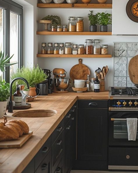 🖤 Dark Boho Kitchen Dreams: Where Edgar Allan Poe Meets Morticia Addams 🍳 Transforming my tiny kitchen into a moody culinary wonderland! Picture this: * Dramatic black cabinets with gleaming brass accents * Classic New York subway tiles for that urban edge * Open shelves showcasing my eclectic collection - glass skulls rubbing elbows with vintage lab beakers 🧪💀 * Shimmering copper pots ready for witchy brews (or just really good pasta) * Lush greenery breathing life into every corner 🌿 It’s a... Black Kitchen Brown Countertop, Moody Retro Kitchen, Copper Black Kitchen, Small Kitchen Black Cabinets, Dark Boho Kitchen, Whimsigoth Kitchen, Masculine Kitchen, Light Goth, Brown Countertop