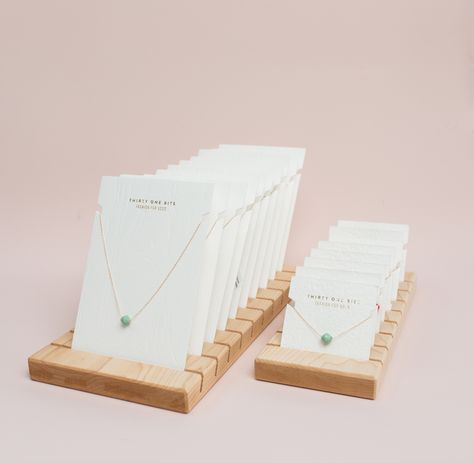 Thirty One Bits Jewelry contacted me for Custom Display Boards and I am so happy with the results. This display looks so clean and natural with their lovely and minimal cards for necklaces and bracelets. Be sure to look up 31 bits too, as this company empowers women in UGANDA, to earn an income and provide for their families by making fashion conscious jewelry. Now that's a win-win-win!!! Diy Bracelet Display Cards, Jewellery Display Cards, Necklace Cards Packaging, Earring Card Display Stands, Jewelry Packaging Design, Business Card Displays, Jewelry Display Cards, Jewerly Making, Jewelry Catalog