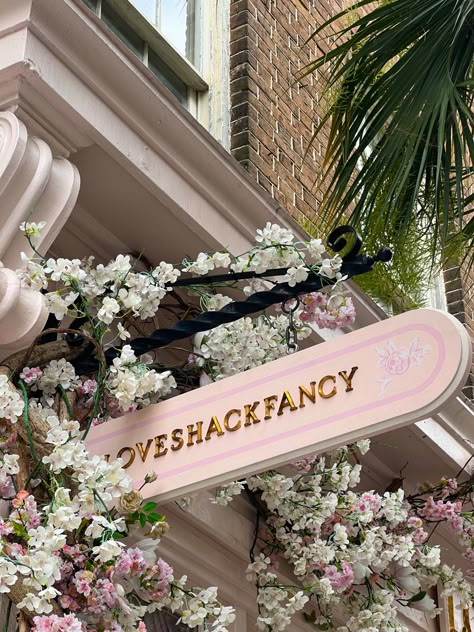 A Sign, Building, Flowers, Pink, White