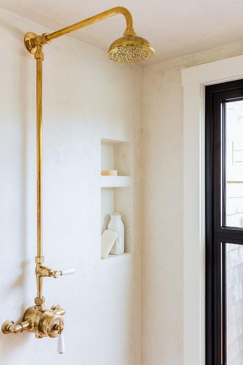 Lovely walk in shower is clad in stucco lined with a gold vintage exposed plumbing shower kit. Waterproof Plaster, Master Bath Layout, Exposed Plumbing, Industrial Style Bathroom, Salt Marsh, Cottage Bathroom, Home Features, Interior Renovation, Shower Kits