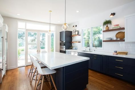 Fabulous kitchen features navy blue shaker cabinets adorned with aged brass pulls paired with white quartz countertops that resemble marble and a white stacked tile backsplash. Navy Kitchen Cabinets, Navy Blue Kitchen Cabinets, White Upper Cabinets, Blue Kitchen Island, Navy Kitchen, Blue Kitchen Cabinets, Blue Cabinets, 아파트 인테리어, Transitional Kitchen