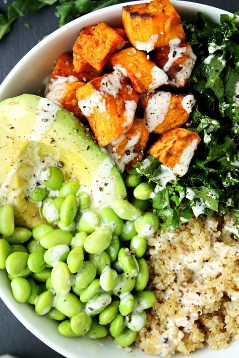 Kale Quinoa Sweet Potato Buddha Bowl Recipe || Made with chopped fresh kale, roasted sweet potatoes, quinoa, avocado, and edamame, and topped with a creamy tahini dressing. #mondaysundaykitchen #buddhabowlrecipes #buddhabowl #besthealthybowls #healthysaladrecipes #sweetpotatobuddhabowl #quinoabuddhabowl #kale Sweet Potato Buddha Bowl, Potato Buddha Bowl, Edamame Recipes, Kale Quinoa, Sweet Potato Bowls, Quinoa Sweet Potato, Buddha Bowls Recipe, Healthy Bowls, Tahini Dressing