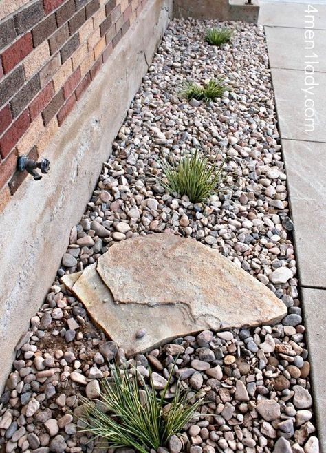 Gravel around the foundation for drainage, plant shrubs along to help soak up water. Like the idea of the large rock to prevent erosion from the water spicket. Maybe a few cool pots or barrels with plants too? I like :) Curb Appeal Without Plants, House Border Landscape, Gravel Flower Bed Ideas, Foundation Landscaping Ideas, Rock Flower Beds In Front Of House, Rock Beds Around House, Cottage Patio, Bed Idea, Backyard Ideas For Small Yards