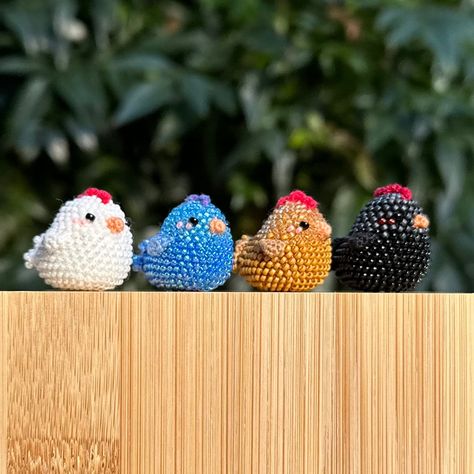 These blushing mini chickens are made to order, with a wide variety of color options. The first 9 color options have different colored beads for the head and body. If you want your chicken to be one solid color, choose from color options 10 through 36. You also have the option to add a keychain to your chicken.  *If you would like a color combination not listed, message me! We can find the perfect colors for you!* The chickens are bead crocheted using a 0.9 mm hook and 2 strands of cotton embroidery thread. Measurements: Chicken is 2.5 cm tall, 2.5 cm wide. Total height including keychain is 7.5 cm. Keychain has a 2.5 cm diameter hoop. ** Disclaimer: This chicken keychain contains small beads and should not be used for or by children or animals. ** Bead Embroidery Keychain, Bead Crochet Amigurumi, Seed Bead Keychain, Beaded Chicken, Chicken Keychain, Seed Bead Crochet, Beaded Animals Tutorial, Thread Crafts, Seed Bead Projects