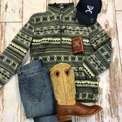 This is a super styling look for a guy this winter! Our Powder River Outfitters line has not disappointed us at all this year (a rare thing for 2020) and this 1/4 zip fleece pullover is no exception. It is heavy fleece in a funky green and blue and cream aztec pattern and matches great with our Hooey Coach ball cap. A pair of Rock & Roll Vintage 46 jeans Twisted X genuine ostrich boots (ON SALE!) and a Twisted X tooled leather trifold wallet complete the look. Get the link to everything you see Mens Ranch Style, Men Western Style Outfits, Southern Outfits Men, Men’s Western Outfits, Cowboy Fits Men, Western Outfits Mens Cowboy, Men’s Western Fashion, Cowboy Clothes For Men, Ariat Mens Outfits