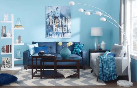 50 Blue Living Room Ideas (Photos) Sky Blue Living Room, Sky Blue Walls, Blue Living Room Walls, Artsy Living Room, Blue Wall Decor Living Room, Blue Living Room Ideas, White Shelving Unit, Blue Couch Living, Blue Walls Living Room