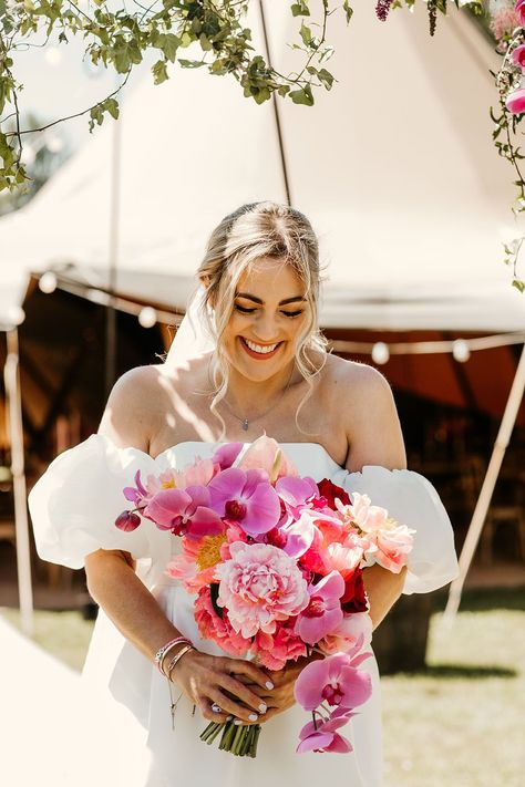 Laughing bride holding bright pink bouquet with orchids and roses Floral Wedding Dress With Bouquet, Bright Orchid Bouquet, Bright Bride Bouquet, Peony And Orchid Wedding Bouquet, Bright Bridal Flowers, Wedding Flower Orchid, Elegant Wedding Vibes, Sunset Bridal Bouquet, Bright Bridesmaid Bouquet