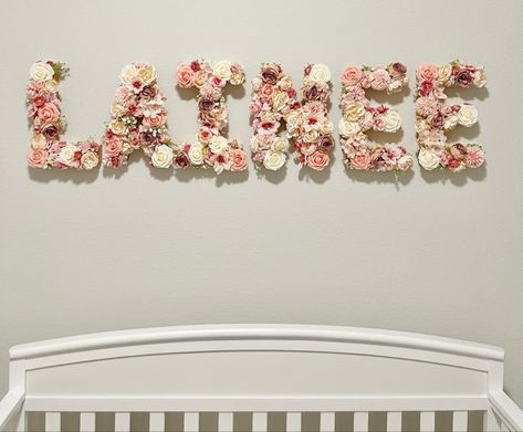 Pink Rose Nursery, Girl Nursery Changing Table, Name On Nursery Wall, Crib Closet, Blanket Ladder Nursery, Diy Name Signs For Nursery, Flower Nursery Baby Girl, Flower Nursery Theme, Diy Name Sign