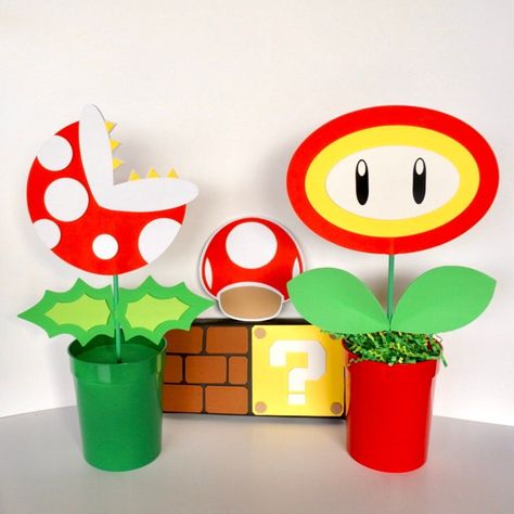 This Super Mario Bros. Centerpieces will brighten your party decoration! The price above is for one complete centerpiece, and your choice of base color. Fire & Ice Flower: Flower face with a blank red back for 1 sided, which can be personalized when choosing 2 sided option. Piranha Plant: Flower Super Mario Bros Table Centerpieces, Super Mario Bros Party Ideas Decoration Diy Brother Birthday, Super Mario Birthday Centerpieces, Mario Party Centerpieces Ideas, Super Mario Candy Bags, Super Mario Party Centerpiece, Super Mario Cricut Projects, Super Mario Bros Classroom Theme, Mario Bros Party Favors