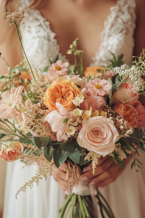 For a wedding that’s full of life, check out these 53 orange and pink bouquets that offer a perfect pop of color. These arrangements will add excitement and vibrancy to your ceremony, making them unforgettable. #popofcolor #orangepinkbouquet #vibrantwedding Pink And Orange Wedding Flowers Bouquets, Fall Wedding Pink And Green, Pink Autumn Wedding Flowers, November Floral Wedding, Orange And Peach Wedding Flowers, Light Pink And Orange Wedding Flowers, Boho Wedding Spring Colors, Wildflower Bouquet Orange, Dusty Rose And Orange Wedding