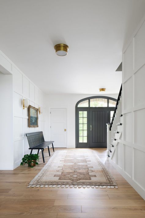 A Modern Classic Renovation (Before + After) - Emily A. Clark Walls Panels, Lighting Entryway, Rug Bench, Foyer With Stairs, Jean Stoffer Design, Jean Stoffer, Modern Classic Home, Paneled Walls, Entryway Design