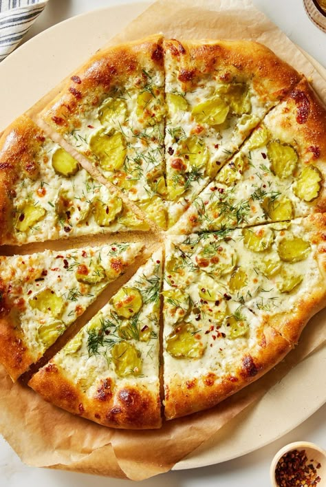 This tasty twist on a classic uses ranch, pickle juice, and dill to make your new favorite pizza. Try our pickle pizza recipe for dinner tonight. Instead of a classic red sauce, this pizza is topped with ranch. It makes a creamy base for tangy dill pickles, mozzarella cheese, and crushed red pepper flakes. #picklepizza #pizzarecipes #homemadepizza #bhg Pickle Pizza Recipe, Pickle Pizza, Pepperoni Recipes, Pizza Cups, Homemade Pizza Dough, Homemade Ranch, Pizza Bites, Pickle Juice, How To Make Pizza