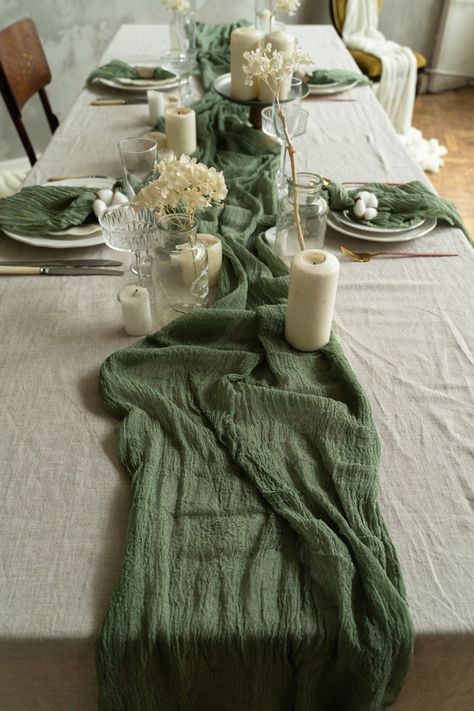 Emerald Rustic Wedding Decor, Green And Beige Wedding Table Decor, Green Cheese Cloth Table Runner Wedding, White Table Cloth With Sage Green Runner, Round Tables Backyard Wedding, Green And Brown Table Setting, Simple Wedding Style Receptions, Boho Greenery Wedding Table Settings, Olive Green Table Runner