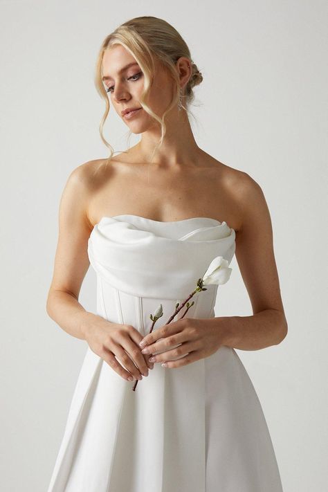 Designed to highlight your best assets in a refined manner, this chic strapless dress will instantly feel meant-to-be. With built in cups and a boned bodice to hold the silhouette in place, this sultry cowl neck gown offers complete support and functionality throughout the day. Made from Karina crepe: presented in an elegant matte finish, this rich fabric drapes over the body with structural fluidity, masterfully tracing and contouring the silhouette. Level of stretch: little. This dress fastens with a rear concealed zip. Cowl Wedding Dress, Cowl Neck Gown, Fancy Dinner Party, Boned Bodice, Satin Wedding Dress, Rich Fabric, Satin Wedding, Draped Fabric, Cowl Neck