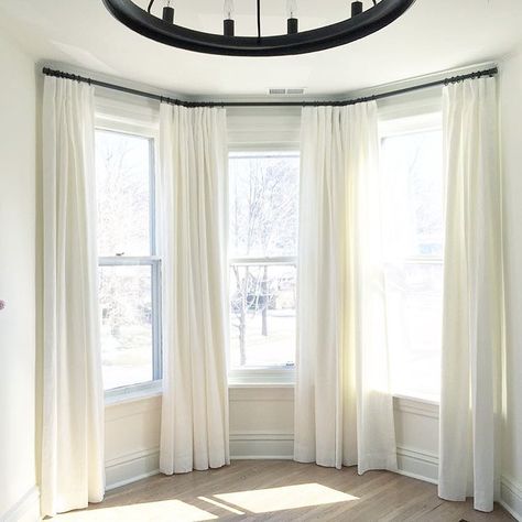 469 Likes, 30 Comments - Tonic Living (@tonicliving) on Instagram: “Bay windows can be a real beast to dress. There's always some kind of solution though...so buck up!…” Curtains Half Window, How To Hang Curtains On Bay Windows, Curtain Rod Bay Window, Alcove Window Curtains, Master Bay Window Ideas, Curtains For Rounded Top Windows, Drapes For Bay Windows, Curved Window Living Room, Dressing Bay Windows